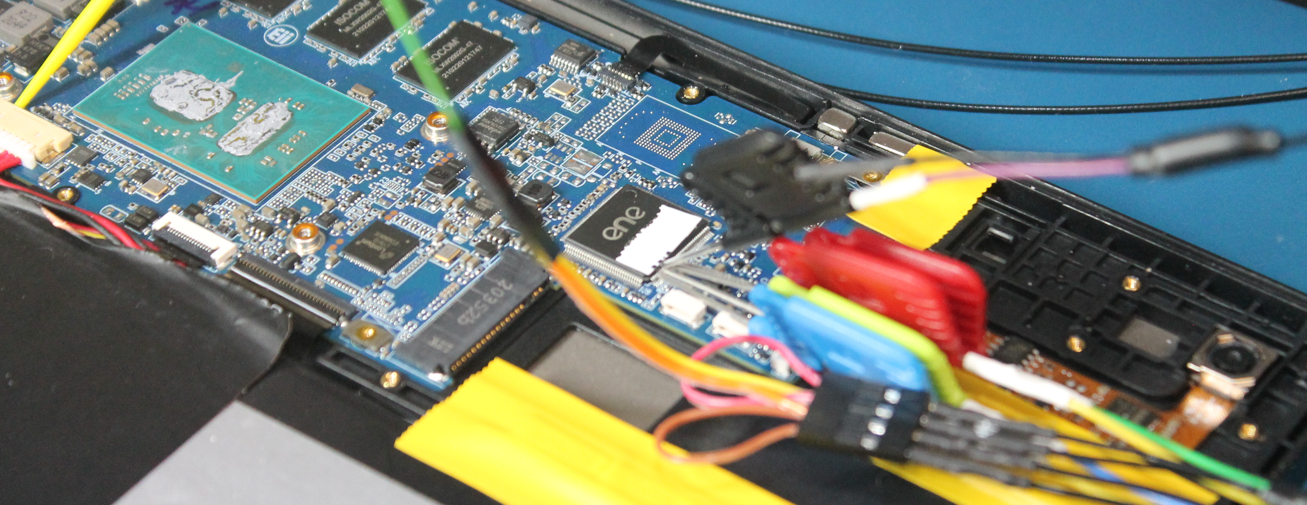 Back of Librem 11, mainboard exposed, with probes connected to the embedded controller chip